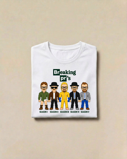 White Breaking pr's muscle fit gym shirt, folded, front view: tile-style lettering above five cartoon characters in different outfits with season captions